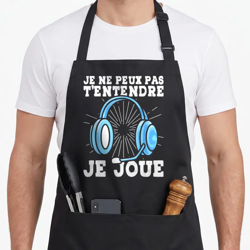 Tablier de cuisine noir avec illustration de casque audio bleu et texte blanc humoristique sur fond uni.