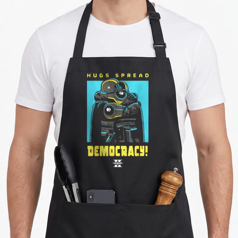 Tablier Helldivers 2 PlayStation Video Game Hugs Spread Democracy — sur un tablier de cuisine noir, fond blanc