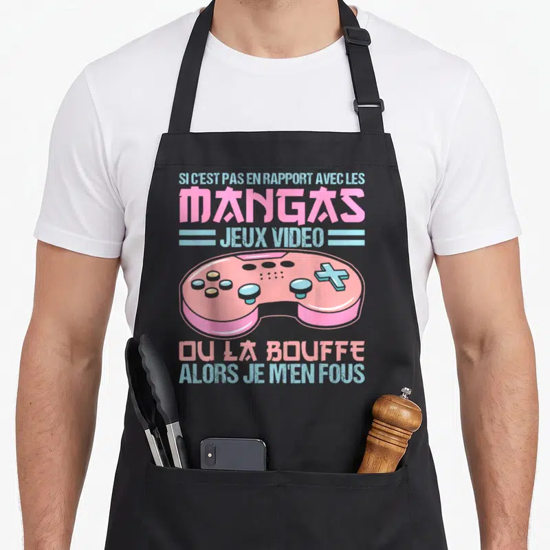 Tablier de cuisine noir avec une manette rose et le texte sur les mangas jeux vidéo ou la bouffe.