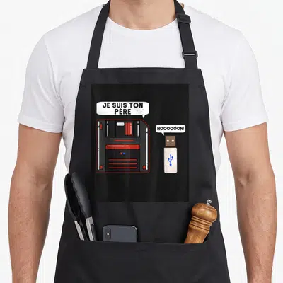 Tablier de cuisine noir avec illustration d'un floppy disk et d'une clé USB USB parlant.
