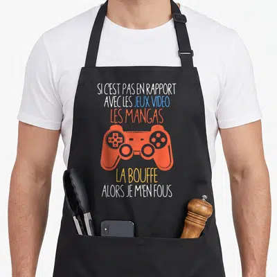 Tablier de cuisine noir orné d'une manette orange et du texte humoristique sur les mangas et les jeux vidéo.