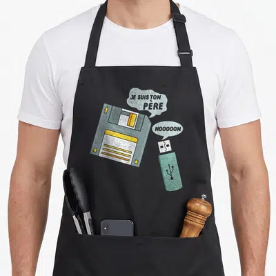 Tablier de cuisine noir avec illustration de disquette et clé USB citant le film.