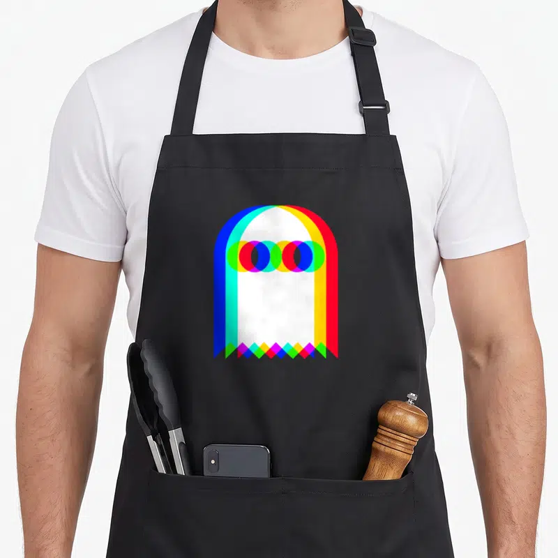 Tablier de cuisine noir avec un fantôme RVB aux couleurs superposées et une base en losanges géométriques.