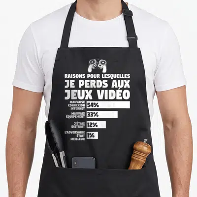 Tablier de cuisine noir avec illustration blanche d'un contrôleur et graphique listant les excuses des gamers pour leurs défaites.