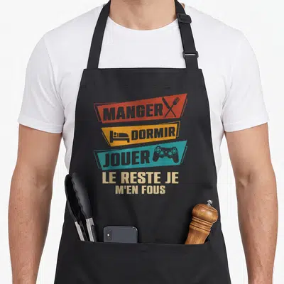 Tablier de cuisine noir avec bandes colorées Manger Dormir Jouer et manette de jeu.