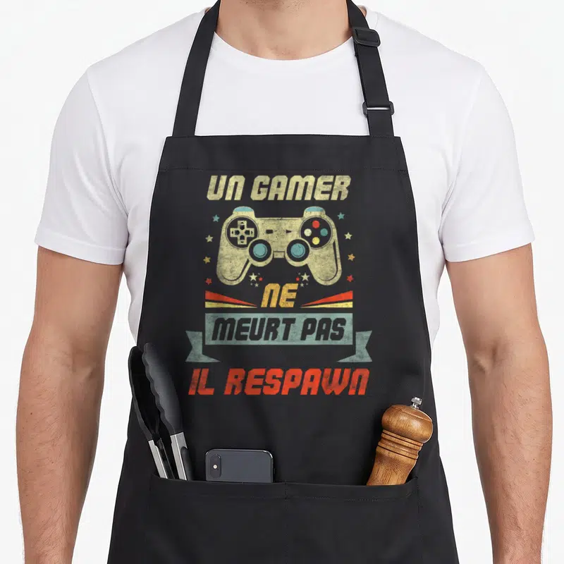 Tablier de cuisine noir avec illustration vintage manette de jeu et texte Un Gamer Ne Meurt Pas Il Respawn.