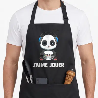 Tablier de cuisine noir avec illustration d'un panda gamer portant des écouteurs et tenant une manette, sous l'inscription J'AIME JOUER.
