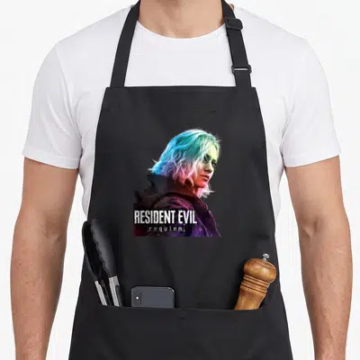 Tablier de cuisine noir avec illustration d'une femme aux cheveux bleus et roses et le texte Resident Evil requiem en bas.