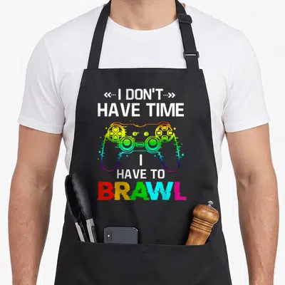 Tablier de cuisine noir avec manette de jeu multicolore et texte blanc I Don't Have Time I Have to Brawl.