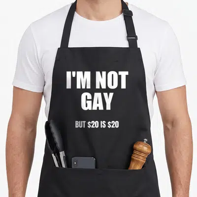Tablier de cuisine noir avec le texte blanc I'm Not Gay But $20 Is $20 centré sur le devant.