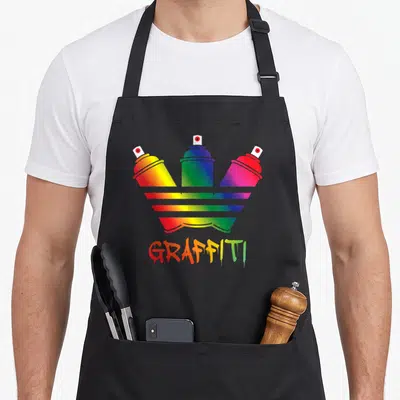 Tablier de cuisine noir avec trois bombes aérosol rainbow et le mot GRAFFITI dégoulinant en bas du design central.