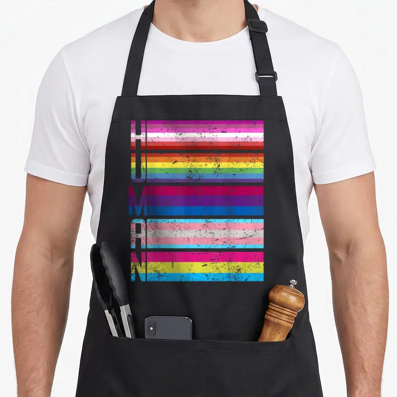 Tablier de cuisine noir avec le mot humain stylisé par des bandes colorées de drapeaux diversifiés.
