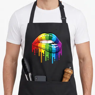 Tablier de cuisine noir avec une illustration de lèvres colorées en arc-en-ciel dont les teintes dégoulinent vers le bas.
