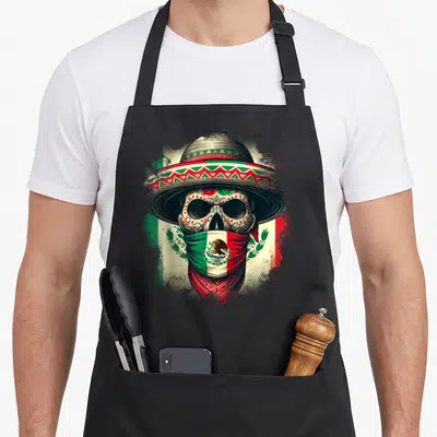 Tablier de cuisine noir avec un crâne orné d'un sombrero et d'un bandana au drapeau mexicain.