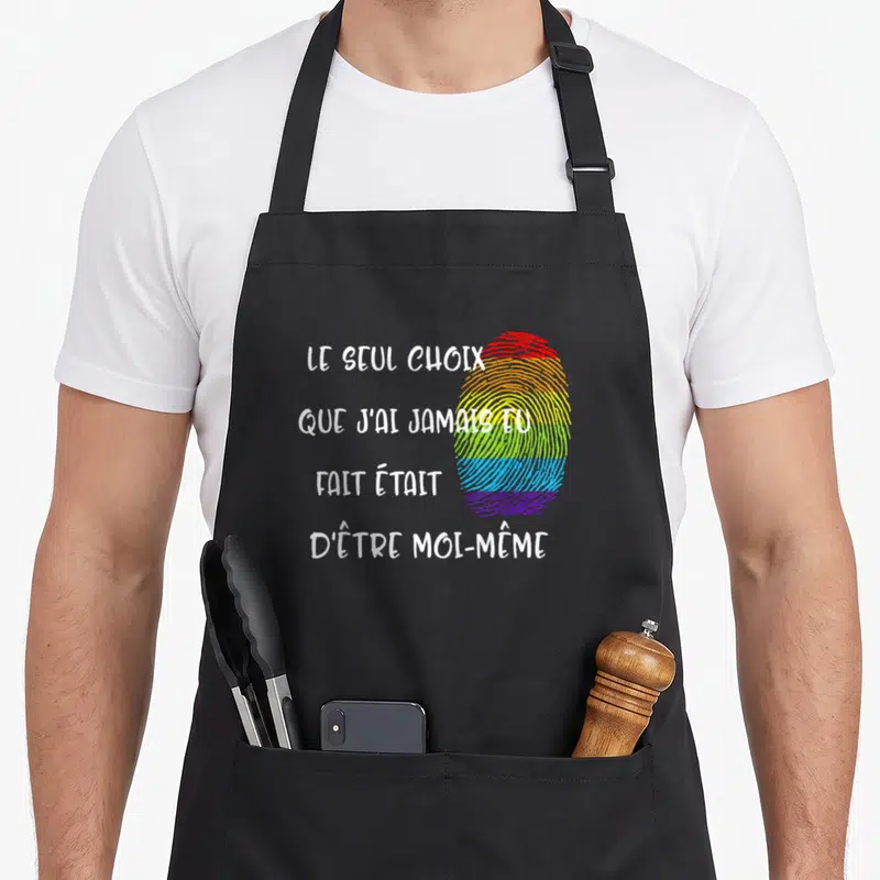 Tablier de cuisine noir avec une empreinte digitale arc-en-ciel et un texte blanc affirmant l'authenticité.