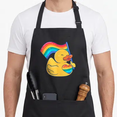 Tablier de cuisine noir avec illustration d'un canard jaune tenant un drapeau arc-en-ciel et un cœur coloré.