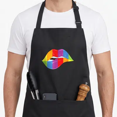 Tablier de cuisine noir avec illustration de lèvres multicolores formant un arc-en-ciel vibrant au centre.