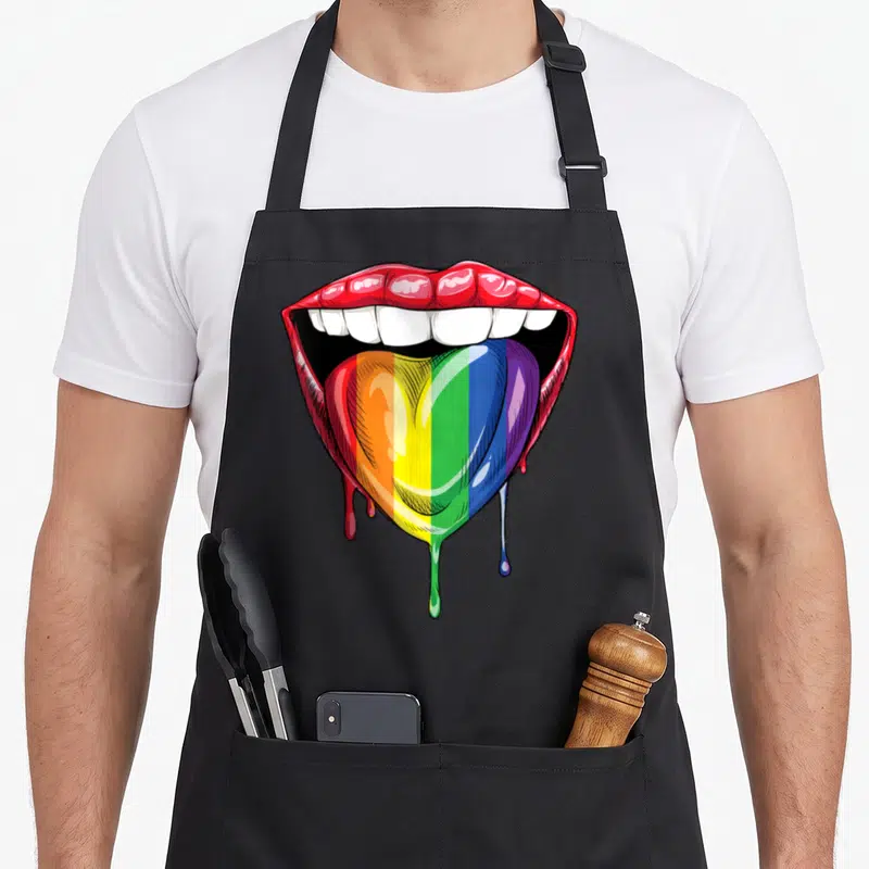 Tablier de cuisine noir avec lèvres rouges et langue en forme de cœur aux couleurs du drapeau arc-en-ciel LGBT.