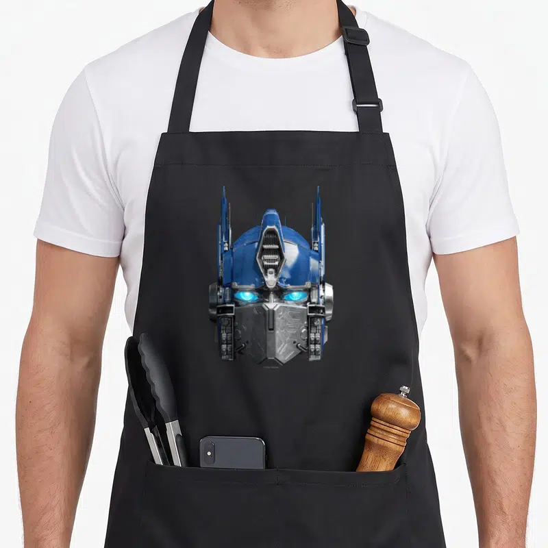 Tablier de cuisine noir avec le visage robotique d'Optimus Prime en bleu et argent.