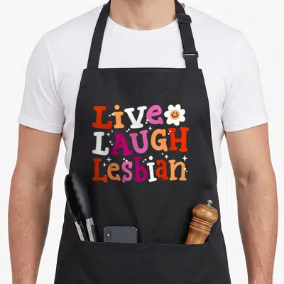 Tablier de cuisine noir avec typographie colorée Live Laugh Lesbian et fleur souriante retro