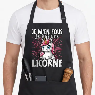 Tablier de cuisine noir avec une licorne rose et blanche et le texte Je m'en fous je suis une licorne