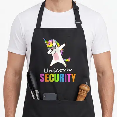 Tablier de cuisine noir avec licorne blanche en train de faire un dab, portant des lunettes noires et le texte Unicorn Security multicolore.