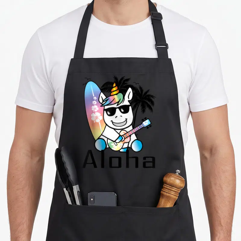 Tablier de cuisine noir avec licorne aux lunettes noires tenant un ukulele et un surf sous des palmiers.