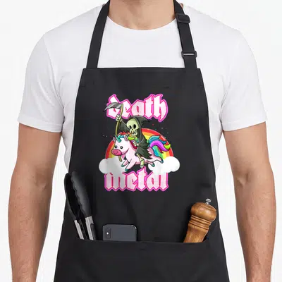 Tablier de cuisine noir avec un Grim Reaper kawaii chevauchant une licorne rose sous les mots Death Metal en lettres roses gothiques.