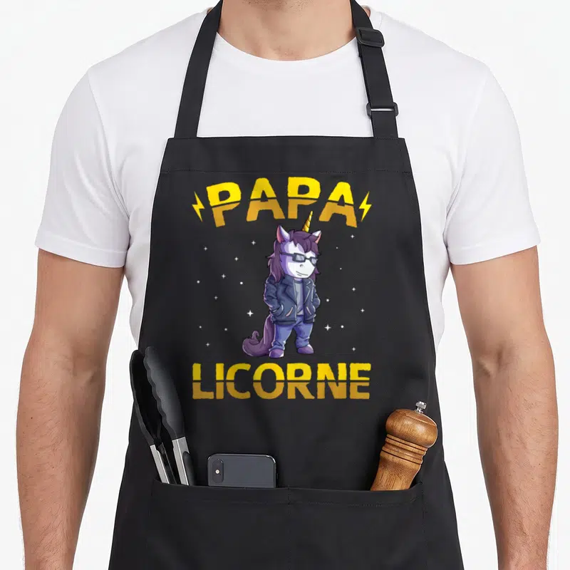 Tablier de cuisine noir avec illustration d'une licorne vêtue d'une veste et portant des lunettes sous les mots Papa Licorne