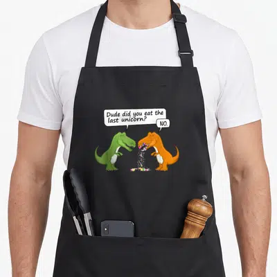 Tablier de cuisine noir avec deux dinosaures colorés et une bulle de dialogue en anglais.