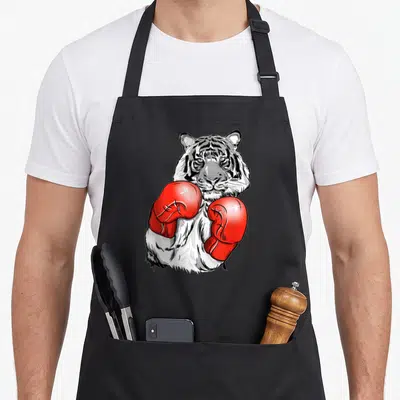 Tablier de cuisine noir avec illustration d'un tige de boxe portant des gants rouges vifs