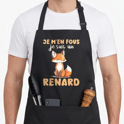 Tablier de cuisine noir avec illustration d'un renard orange et blanc et texte humoristique en lettres capitales.