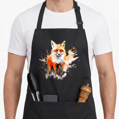 Tablier de cuisine noir avec un renard peint à l'aquarelle aux teintes orangées et blanches sur fond uni.