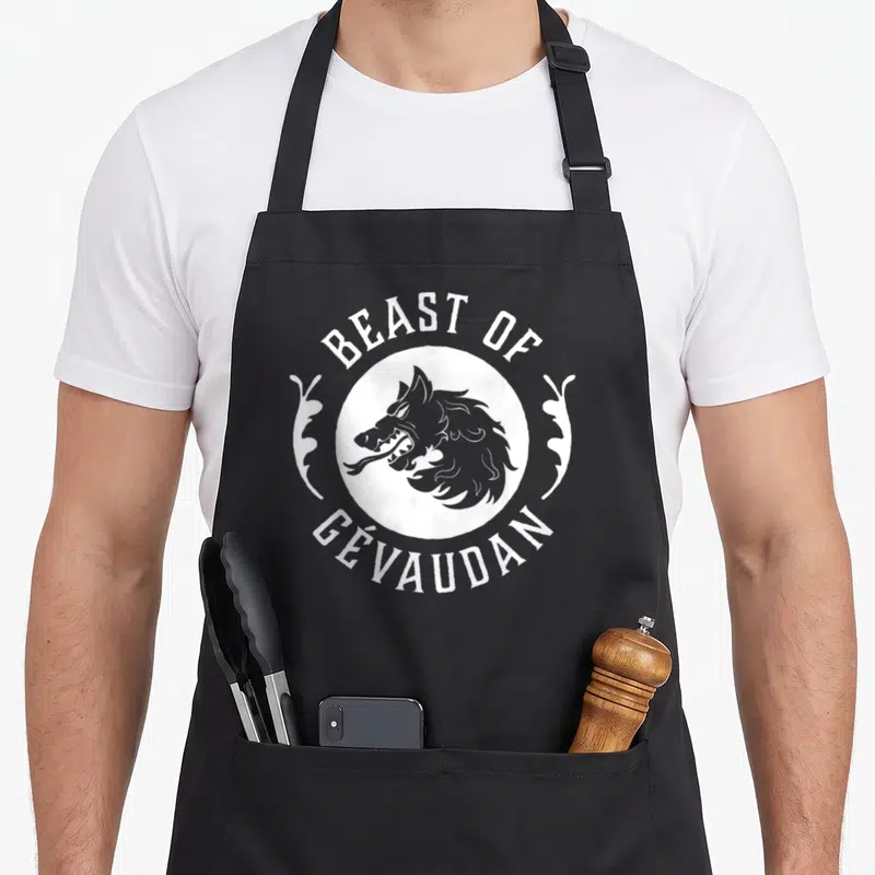 Tablier de cuisine noir avec illustration blanche d'une bête sauvage et texte Beast of Gévaudan.
