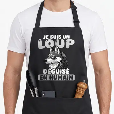 Tablier de cuisine noir avec illustration de tête de loup et texte blanc Je suis un loup déguisé en humain