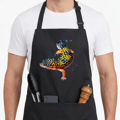 Tablier de cuisine noir avec un gecko léopard multicolore en style aquarelle et éclats de peinture.