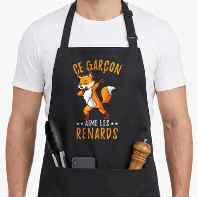Tablier de cuisine noir avec un renard orange effectuant une pose de danse dab au centre du motif imprimé.