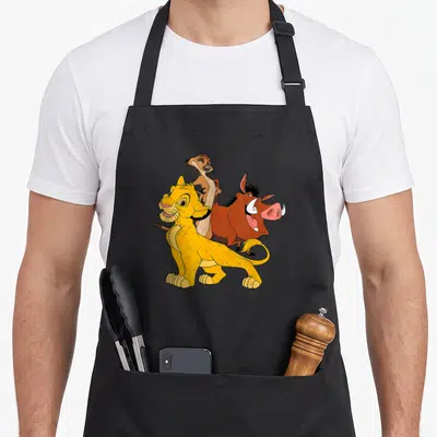Tablier de cuisine noir avec Simba, Pumba et Timon en couleur sur le devant