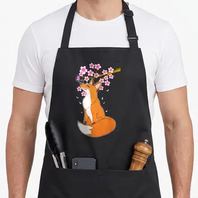 Tablier de cuisine noir avec illustration d'un renard roux sous un cerisier en fleurs et un papillon.