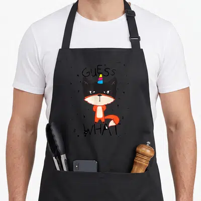 Tablier de cuisine noir avec illustration de renard orange à corne d'unicorne et texte Guess What.