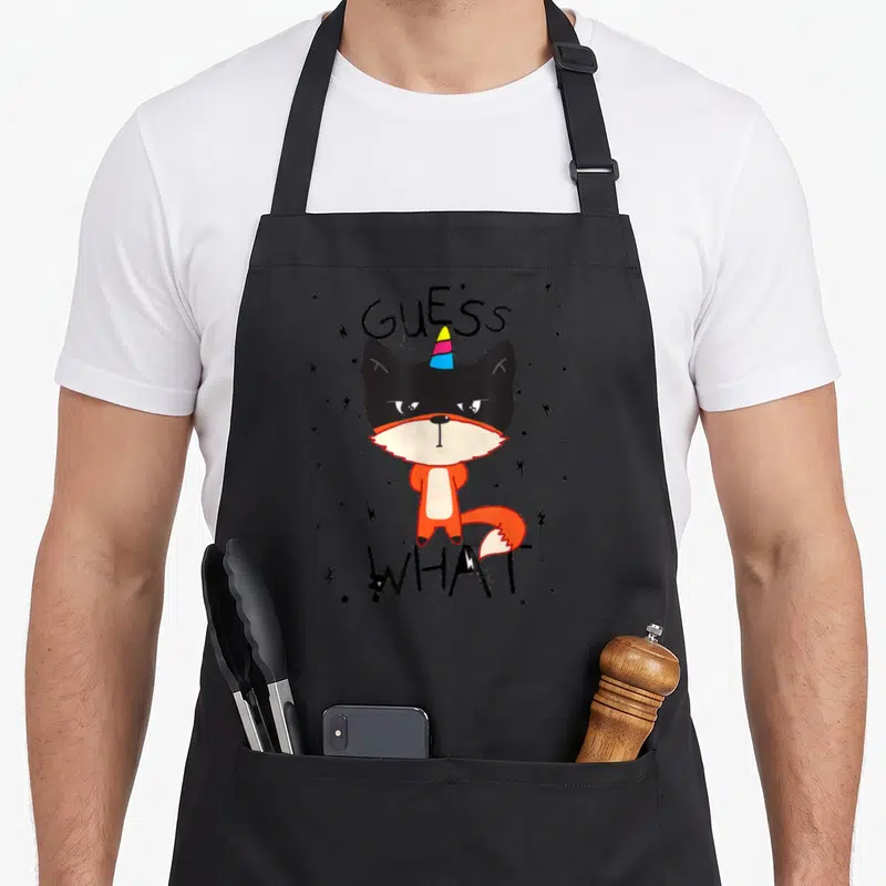 Tablier de cuisine noir avec illustration de renard orange à corne d'unicorne et texte Guess What.