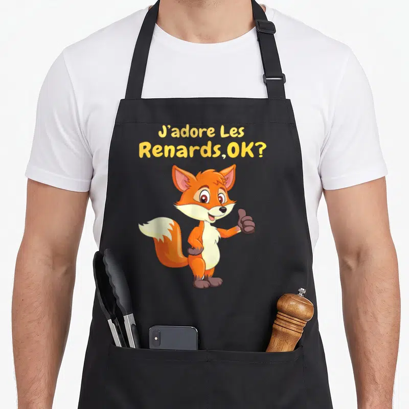 Tablier de cuisine noir avec illustration d'un renard orange souriant et texte jaune J'adore Les Renards OK.