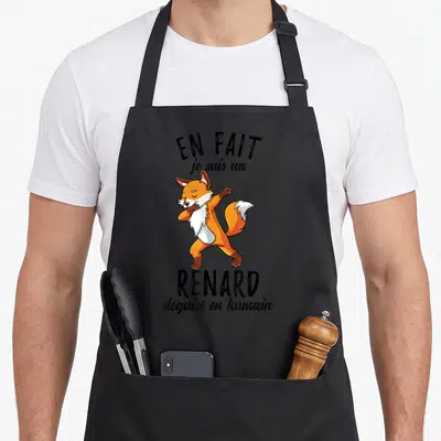Tablier de cuisine noir avec un renard orange effectuant une pose de danse dab et du texte humoristique en noir.