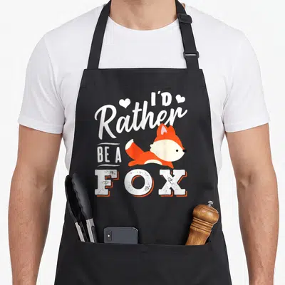 Tablier de cuisine noir avec un renard orange et le texte Je préférerais être un renard en blanc.