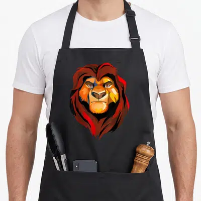 Tablier de cuisine noir avec un lion aux traits géométriques et une mane rougeoyante.