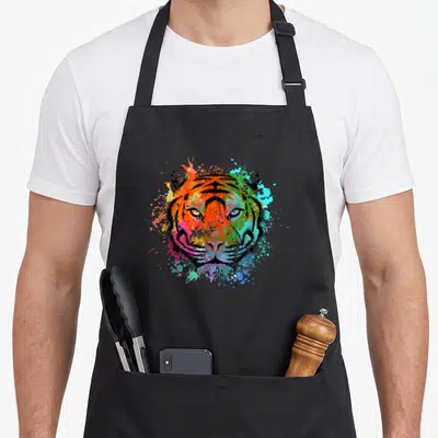 Tablier de cuisine noir avec tête de tigre multicolore style éclaboussure artistique.