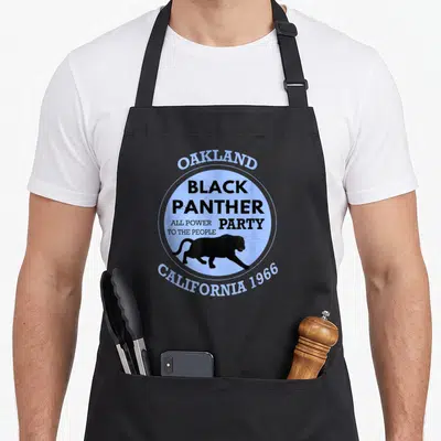 Tablier de cuisine noir avec logo circulaire bleu Black Panther Party Oakland 1966 et silhouette de panthère noire marchant.