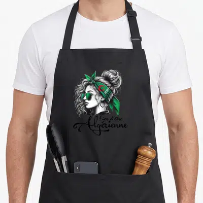 Tablier de cuisine noir avec illustration d'une femme au bandeau vert et texte Fier d'être Algérienne