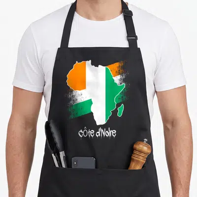 Tablier de cuisine noir avec carte Afrique drapeau Côte d'Ivoire orange vert et texte graffiti blanc.