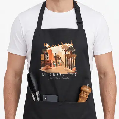 Tablier de cuisine noir avec illustration de Marrakech, palmiers et texte Just Like a Paradise.